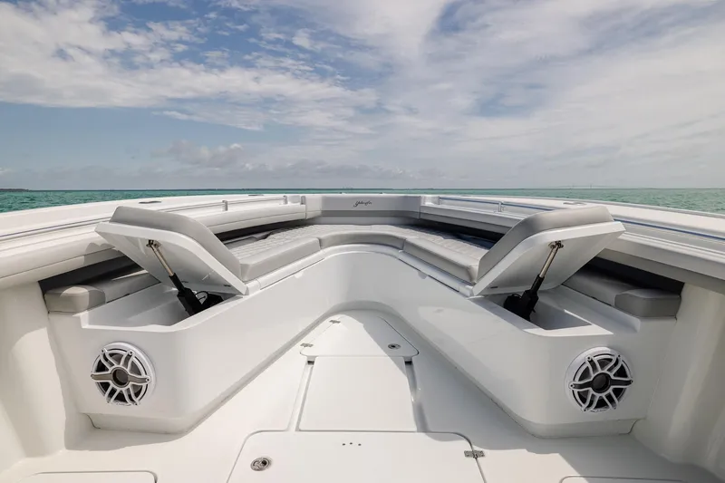Slide: The Image of 2023 Yellowfin 39 Offshore boat interior with cushioned seating and ocean view. - 13