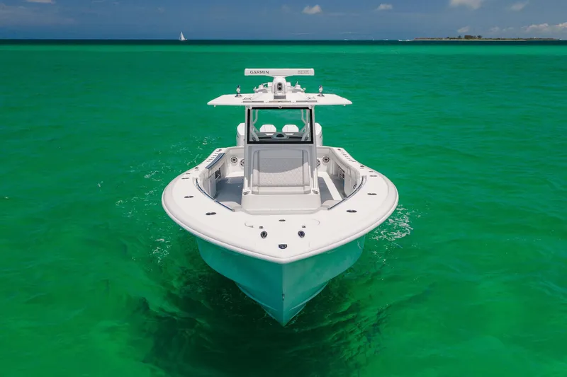 Slide: The Image of 2023 Yellowfin 39 Offshore boat on vibrant turquoise water, front view. - 4