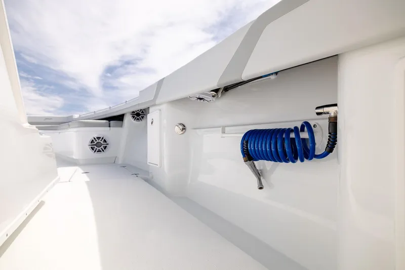 Slide: The Image of 2023 Yellowfin 39 Offshore boat deck with coiled blue hose and speakers. - 19