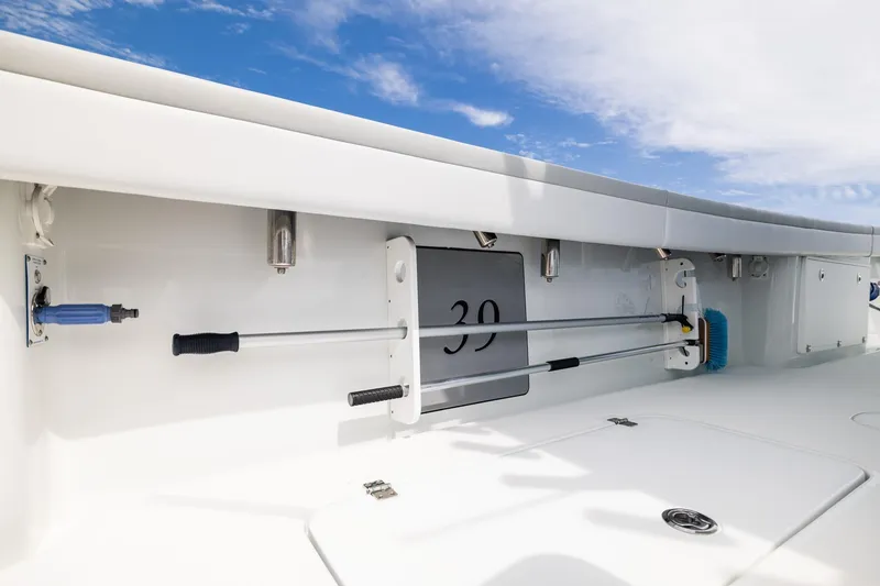 Slide: The Image of 2023 Yellowfin 39 Offshore boat deck with storage and cleaning tools. - 32