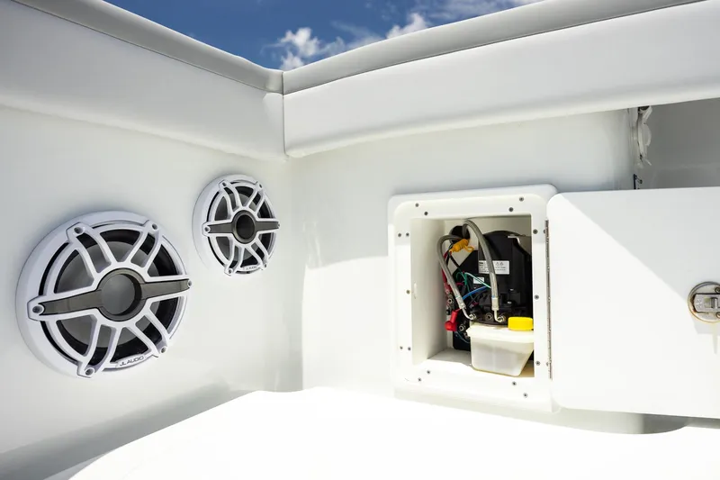 Slide: The Image of 2023 Yellowfin 39 Offshore boat speakers and open electrical compartment under clear blue sky. - 41