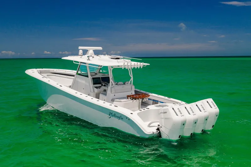 Slide: The Image of 2023 Yellowfin 39 Offshore boat cruising on vibrant turquoise waters under a clear blue sky. - 2