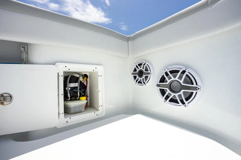 Slide: The Image of 2023 Yellowfin 39 Offshore boat speakers and storage compartment under clear blue sky. - 42