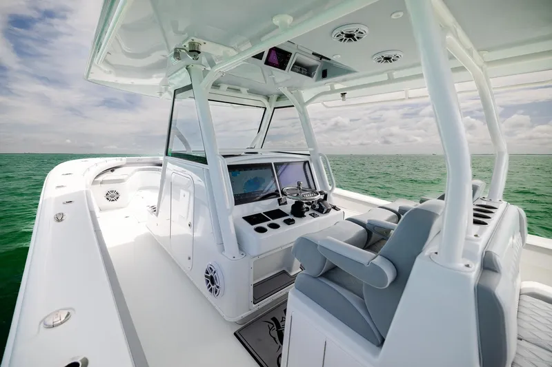 Slide: The Image of 2023 Yellowfin 39 Offshore boat interior with helm, seats, and ocean view. - 24