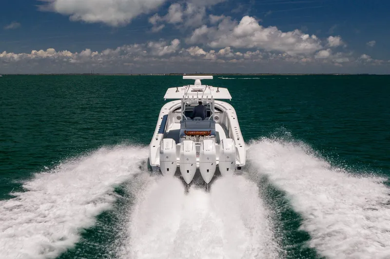 Slide: The Image of 2023 Yellowfin 39 Offshore boat cruising on open water under a partly cloudy sky. - 9