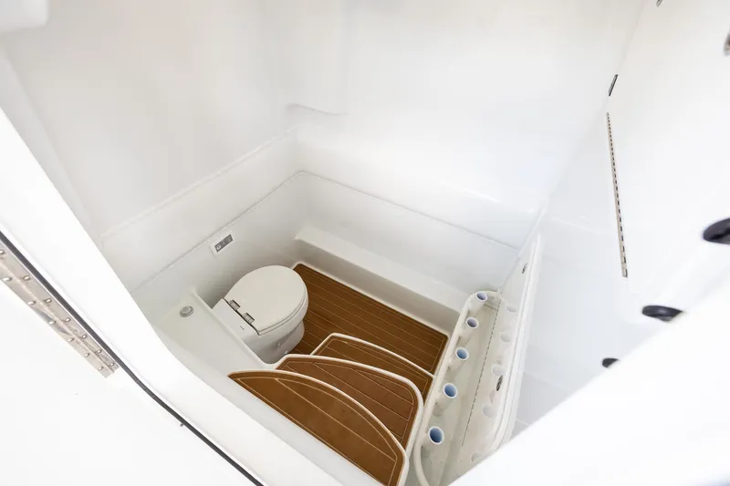 Slide: The Image of 2023 Yellowfin 39 Offshore boat interior with toilet and wooden flooring. - 50