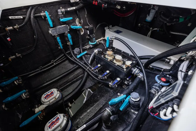 Slide: The Image of Engine compartment of 2023 Yellowfin 39 Offshore boat, showcasing intricate wiring and plumbing systems. - 47
