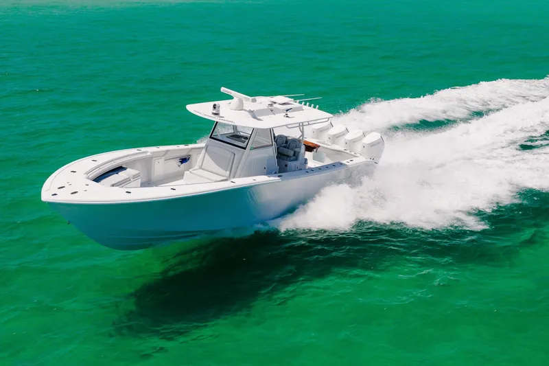Slide: The Image of 2023 Yellowfin 39 Offshore boat cruising on turquoise water. - 10