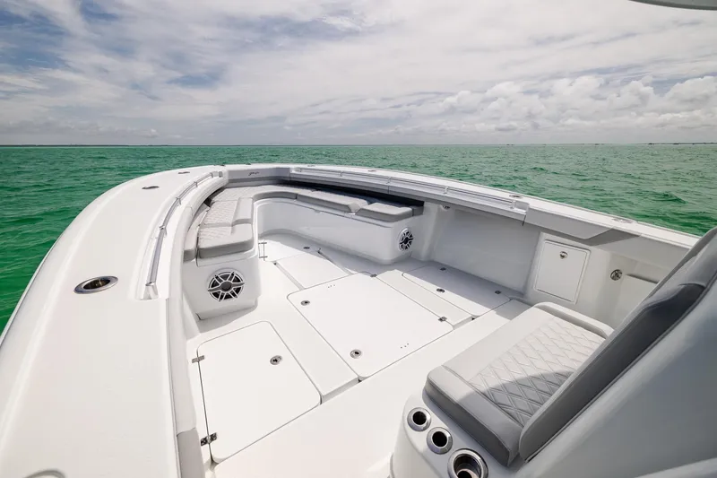 Slide: The Image of 2023 Yellowfin 39 Offshore boat interior with seating, on calm green water. - 12