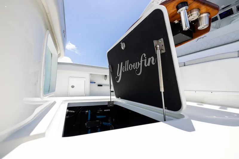 Slide: The Image of Open hatch on 2023 Yellowfin 39 Offshore boat under clear blue sky. - 46