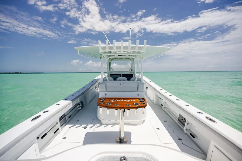 Slide: The Image of 2023 Yellowfin 39 Offshore boat on turquoise water under a clear blue sky. - 28