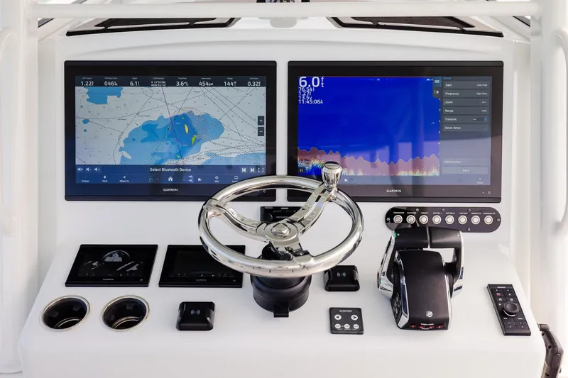 Slide: The Image of 2023 Yellowfin 39 Offshore boat dashboard with dual Garmin displays and steering wheel. - 26