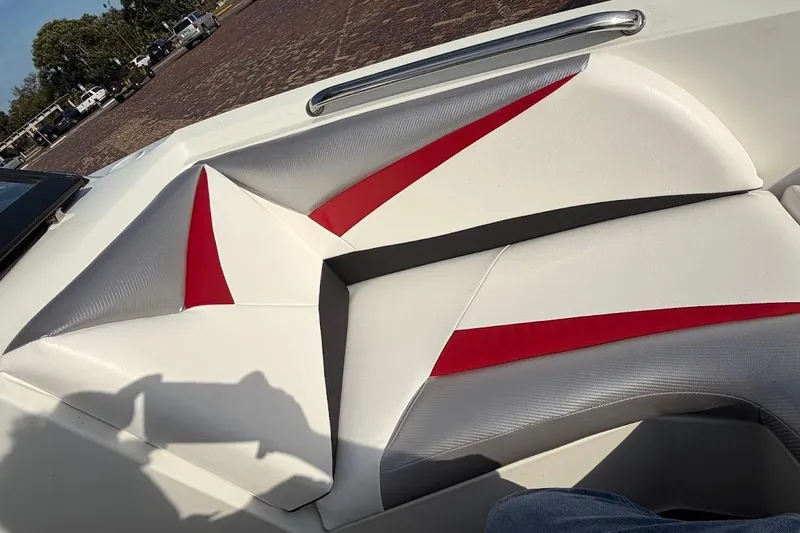 Slide: The Image of 2012 Tigé R20 boat interior with red and gray accents on white seating. - 13