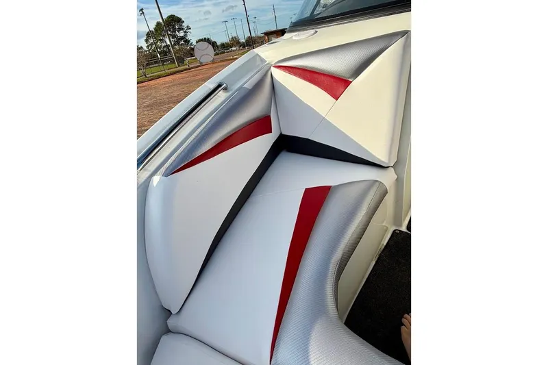 Slide: The Image of 2012 Tigé R20 boat interior with red, white, and gray seating design. - 14