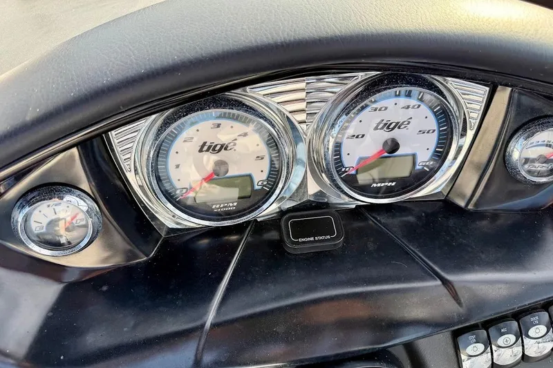 Slide: The Image of Dashboard of a 2012 Tigé R20 boat with speedometer and tachometer gauges. - 19