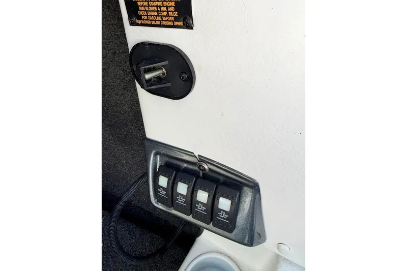 Slide: The Image of Control panel of a 2012 Tigé R20 boat with switches and wiring. - 20