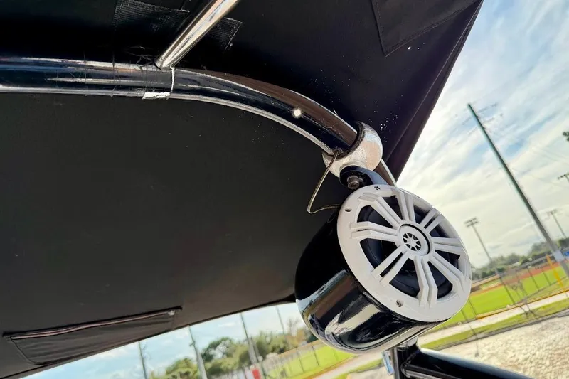 Slide: The Image of Speaker mounted on a 2012 Tigé R20 boat's black canopy frame. - 25