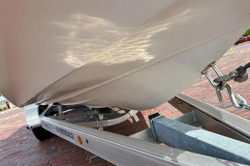 Slide: The Image of 2012 Tigé R20 boat hull on trailer, showing underside and chain attachment. - 29