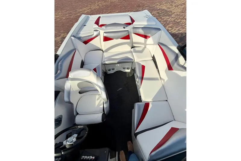 Slide: The Image of Interior of a 2012 Tigé R20 boat with white and red seating. - 6