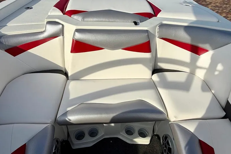 Slide: The Image of 2012 Tigé R20 boat interior with red and white seating, featuring cup holders and speakers. - 8