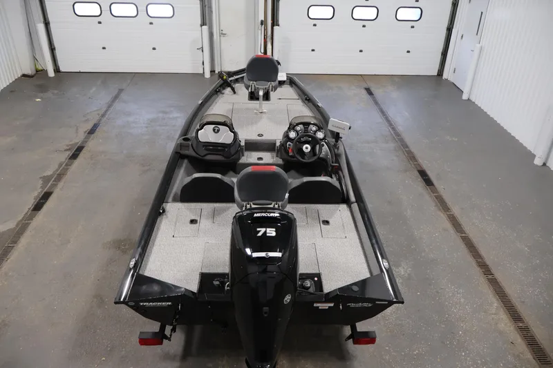 Slide: The Image of 2022 Tracker Pro Team 175 TXW boat in a garage, featuring a Mercury 75 engine. - 10