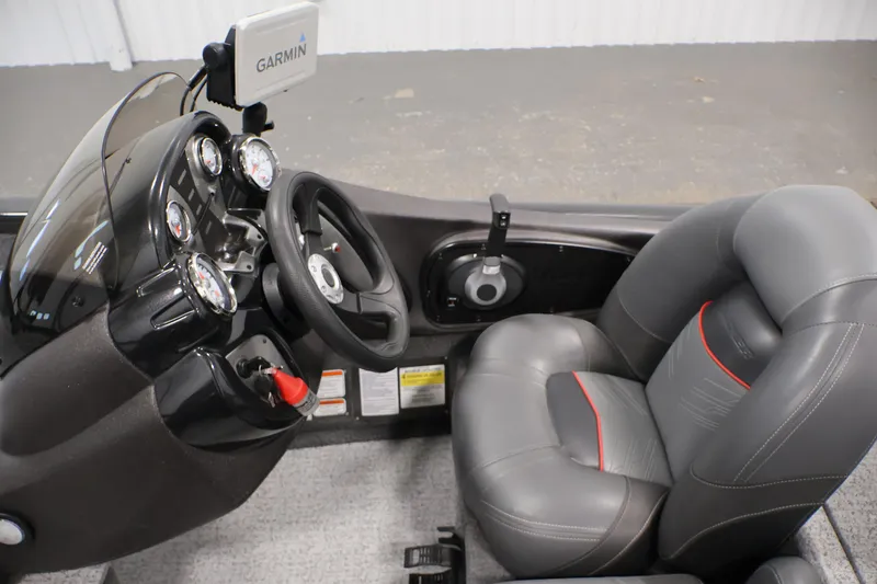 Slide: The Image of 2022 Tracker Pro Team 175 TXW boat cockpit with Garmin GPS and gray seating. - 22