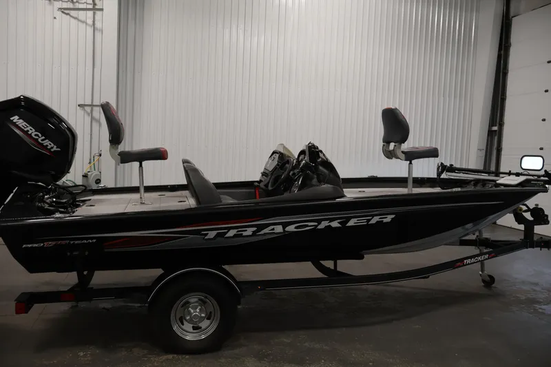 Slide: The Image of 2022 Tracker Pro Team 175 TXW boat in a garage, featuring a Mercury engine. - 4