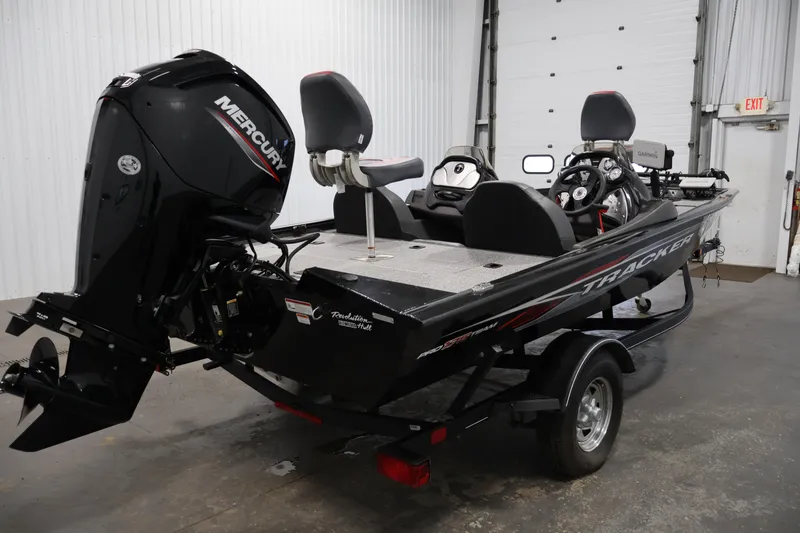 Slide: The Image of 2022 Tracker Pro Team 175 TXW boat with Mercury engine in a garage setting. - 5