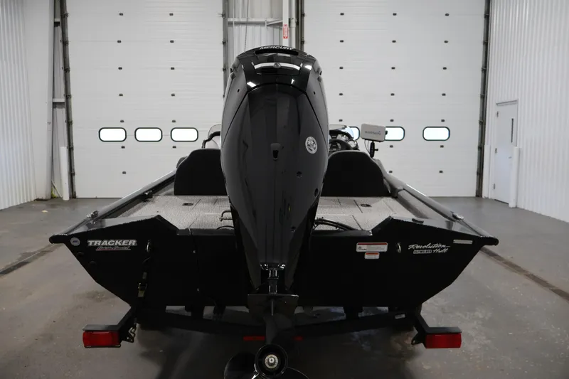 Slide: The Image of 2022 Tracker Pro Team 175 TXW boat in a garage, rear view. - 6