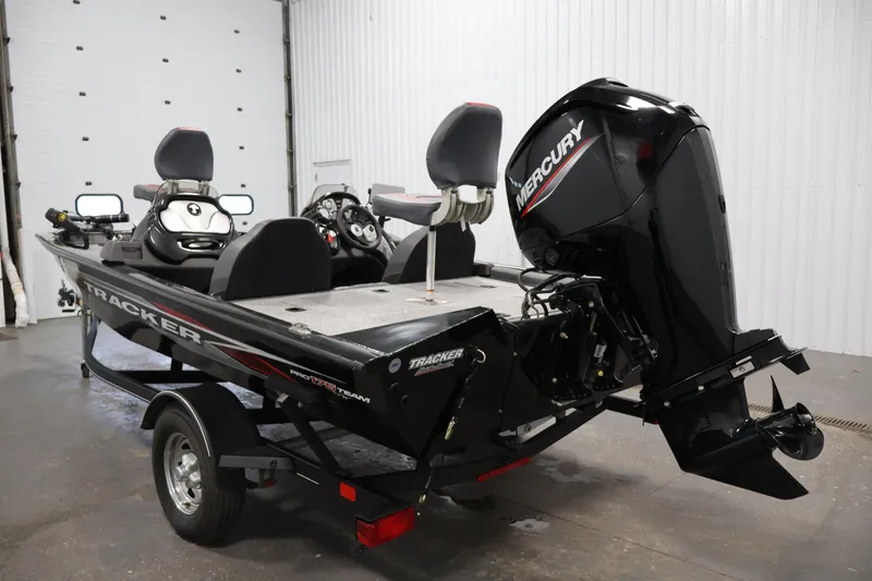 Slide: The Image of 2022 Tracker Pro Team 175 TXW boat with Mercury engine in a garage setting. - 7