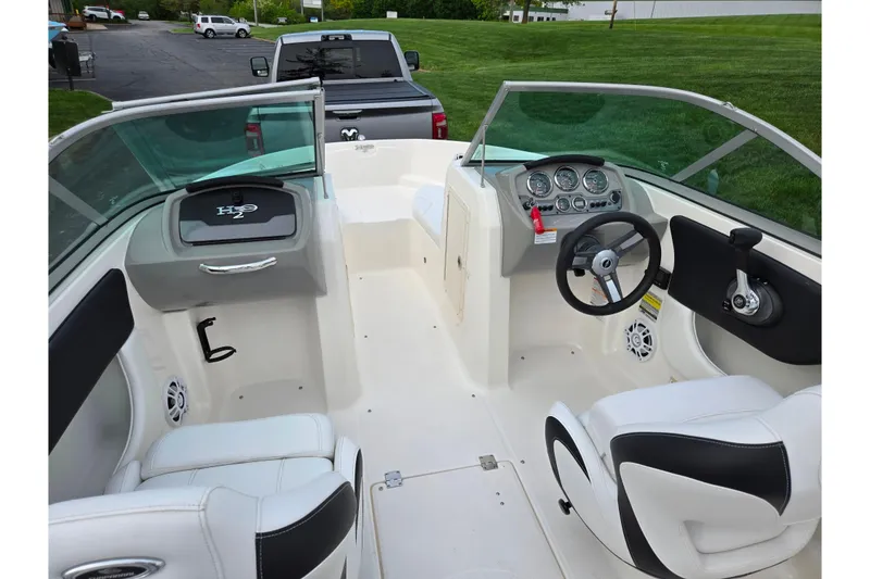 Slide: The Image of 2016 Chaparral 19 H2O Sport boat interior with steering wheel and seating. - 11