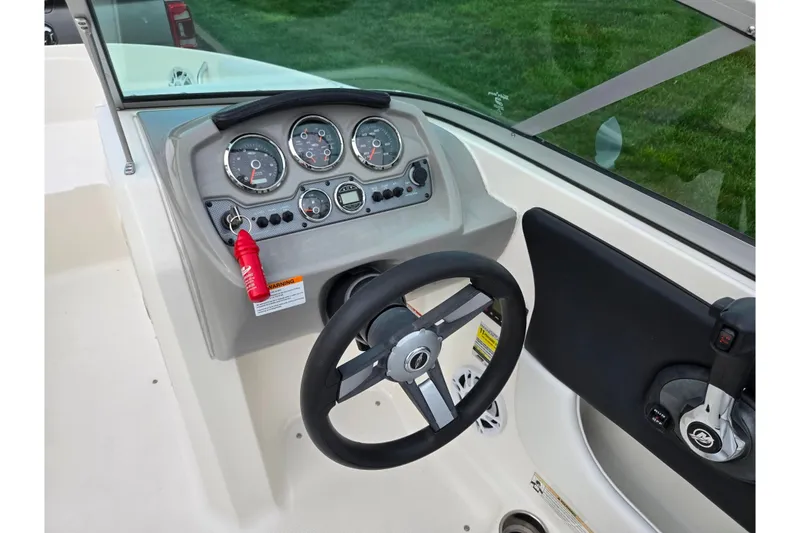 Slide: The Image of 2016 Chaparral 19 H2O Sport boat dashboard with steering wheel and instrument panel. - 13