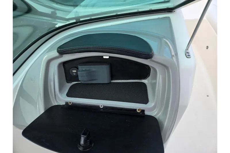 Slide: The Image of 2016 Chaparral 19 H2O Sport boat dashboard with storage compartment and USB port. - 15