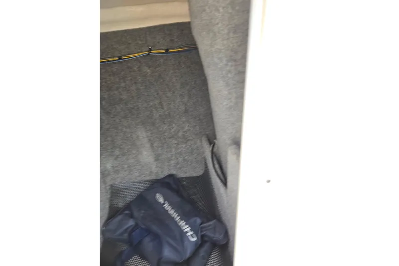 Slide: The Image of Interior storage compartment of 2016 Chaparral 19 H2O Sport boat with a blue bag. - 17