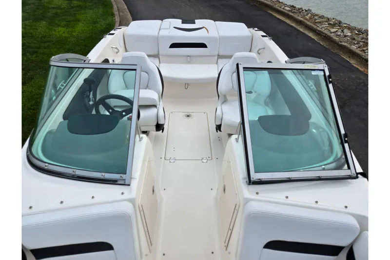 Slide: The Image of 2016 Chaparral 19 H2O Sport boat interior with white seating and dual windshields. - 21