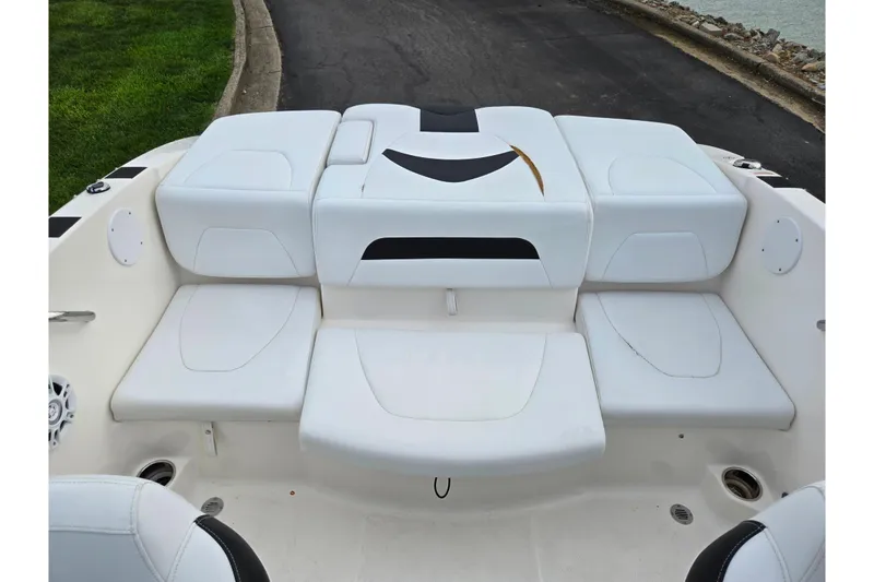 Slide: The Image of 2016 Chaparral 19 H2O Sport boat interior with white cushioned seating. - 23