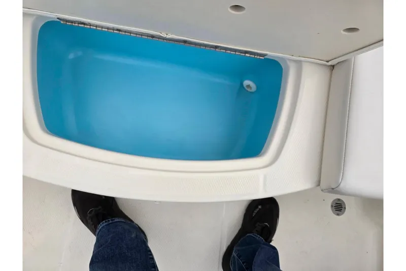 Slide: The Image of 2016 Chaparral 19 H2O Sport boat interior with blue storage compartment. - 24