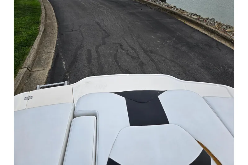 Slide: The Image of 2016 Chaparral 19 H2O Sport boat on a paved road near water. - 27