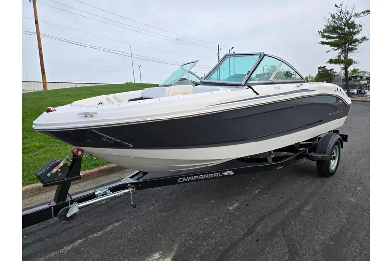 Slide: The Image of 2016 Chaparral 19 H2O Sport boat on trailer, parked on asphalt near grass. - 5