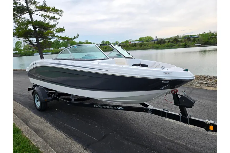 Slide: The Image of 2016 Chaparral 19 H2O Sport boat on trailer by a scenic lake. - 8