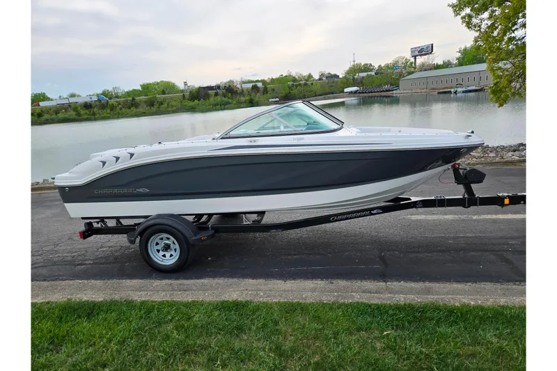 Slide: The Image of 2016 Chaparral 19 H2O Sport boat on trailer by a lakeside road. - 9