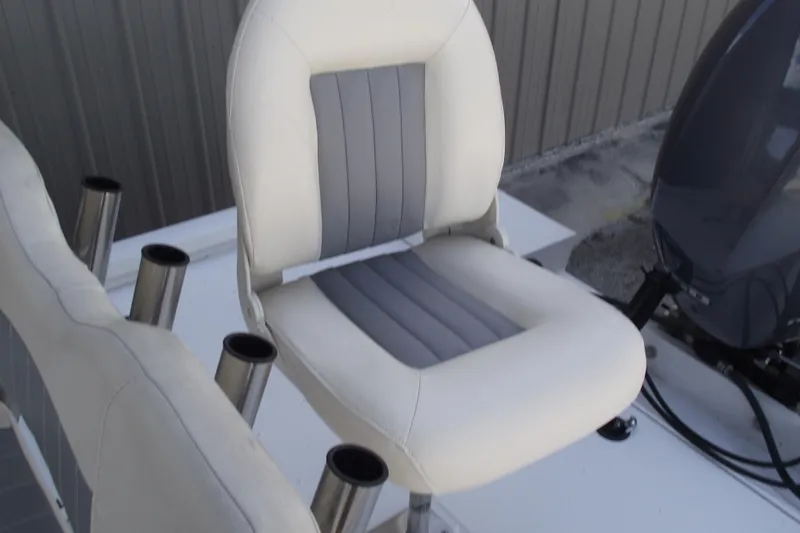 Slide: The Image of 2023 G3 Bay 20 GX boat seat with rod holders, featuring white and gray upholstery. - 22