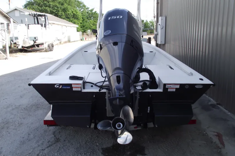 Slide: The Image of 2023 G3 Bay 20 GX boat with powerful outboard motor, parked outdoors. - 3