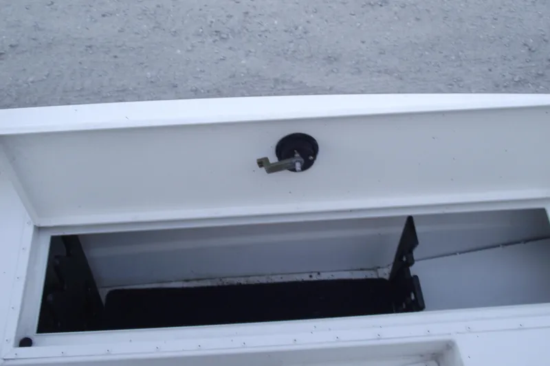 Slide: The Image of 2023 G3 Bay 20 GX boat storage compartment with open hatch and latch mechanism. - 9