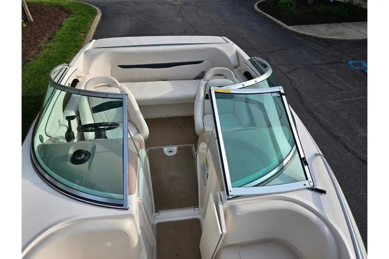 Slide: The Image of Interior view of a 2000 Chaparral 186 SSi boat, featuring seating and windshield. - 18