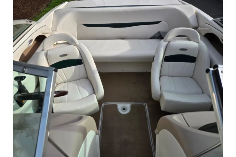 Slide: The Image of Interior of a 2000 Chaparral 186 SSi boat with white seating and steering wheel. - 19