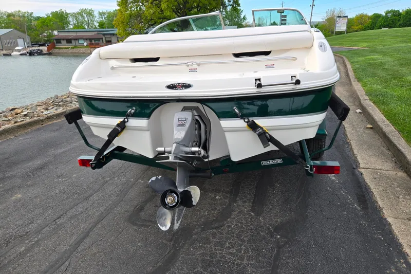 Slide: The Image of Rear view of a 2000 Chaparral 186 SSi boat on a trailer by a lake. - 2