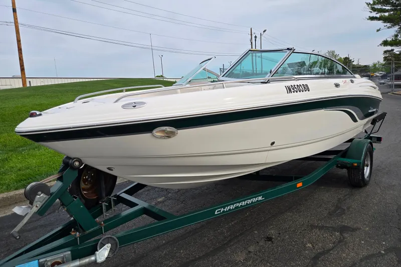 Slide: The Image of 2000 Chaparral 186 SSi boat on trailer, parked on asphalt near green grass. - 5
