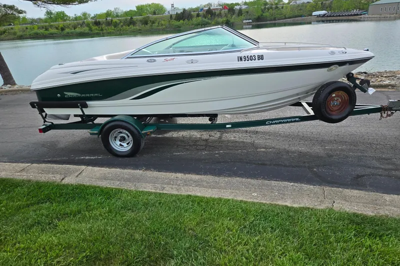 Slide: The Image of 2000 Chaparral 186 SSi boat on trailer by a lakeside road. - 9