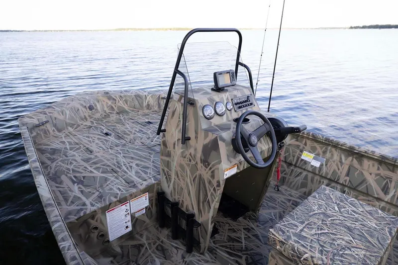 Slide: The Image of Manufacturer Provided Image: 2026 Crestliner 1660 Retriever FCC boat with camouflage design on a serene lake. - 3